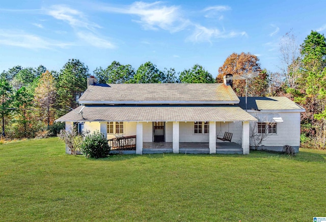 back of house featuring a lawn and a patio area