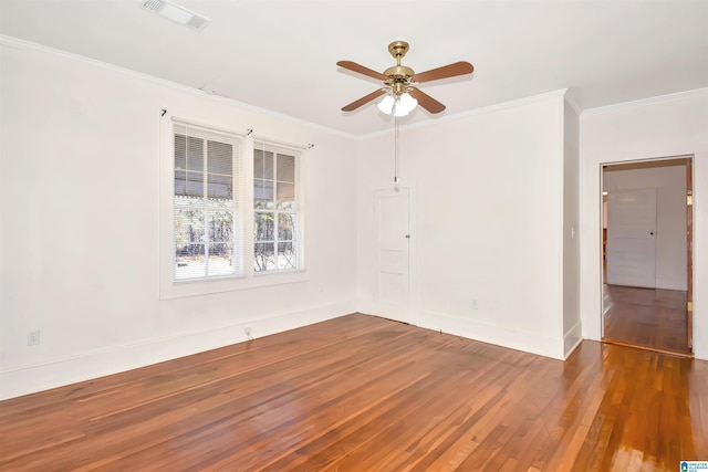 unfurnished room featuring dark hardwood / wood-style flooring, ceiling fan, and crown molding