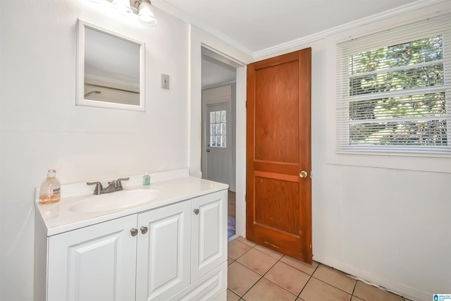 bathroom featuring tile patterned flooring, vanity, and crown molding