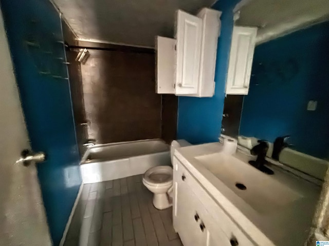 full bathroom featuring vanity, toilet, wood-type flooring, and bathing tub / shower combination