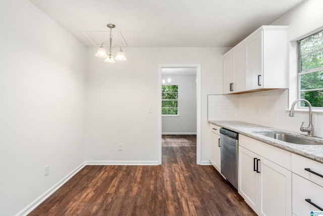 kitchen with sink, tasteful backsplash, light stone counters, stainless steel dishwasher, and white cabinets