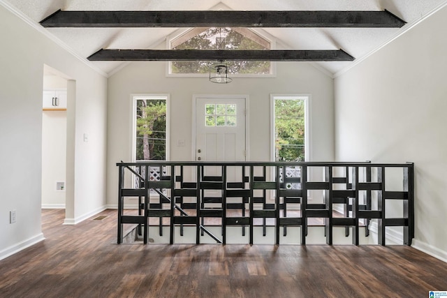 dining room with vaulted ceiling with beams and dark wood-type flooring