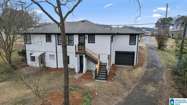 rear view of house featuring a garage