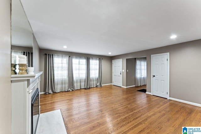 unfurnished living room featuring wood-type flooring