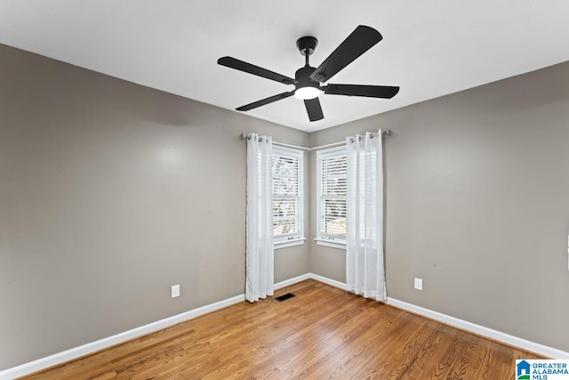 spare room featuring ceiling fan and light hardwood / wood-style floors