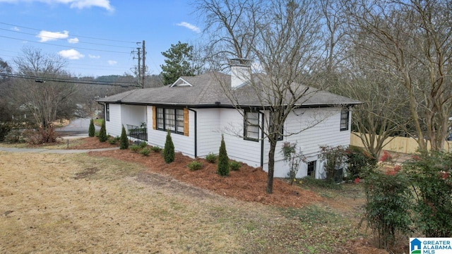 view of property exterior with a lawn