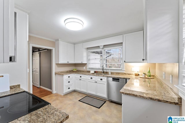 kitchen featuring light stone counters, stainless steel dishwasher, sink, a barn door, and white cabinets