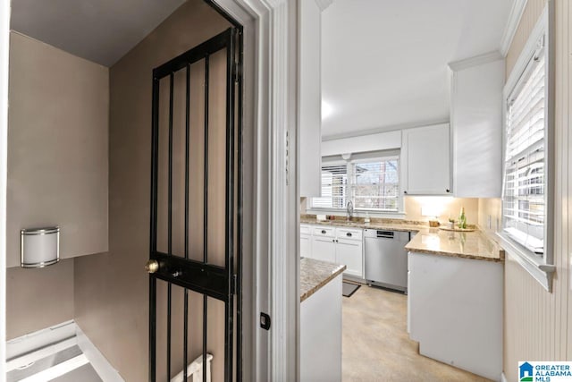 kitchen with dishwasher, crown molding, light stone countertops, light colored carpet, and white cabinetry