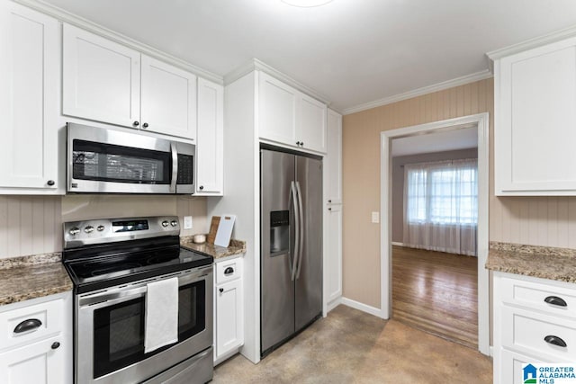 kitchen featuring white cabinets, appliances with stainless steel finishes, and dark stone counters