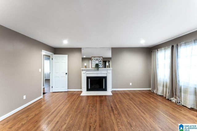 unfurnished living room featuring wood-type flooring