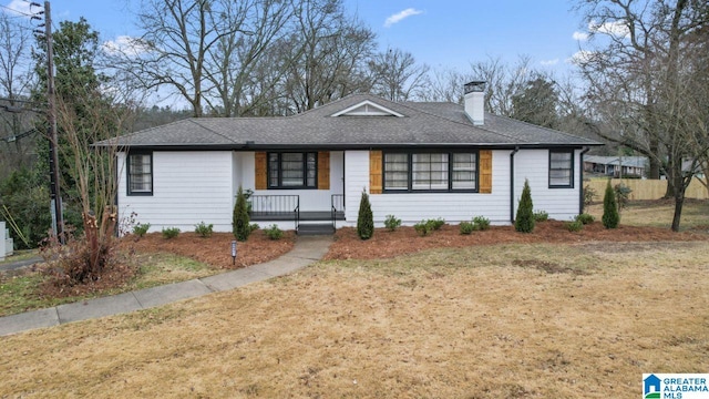 ranch-style house with covered porch and a front yard