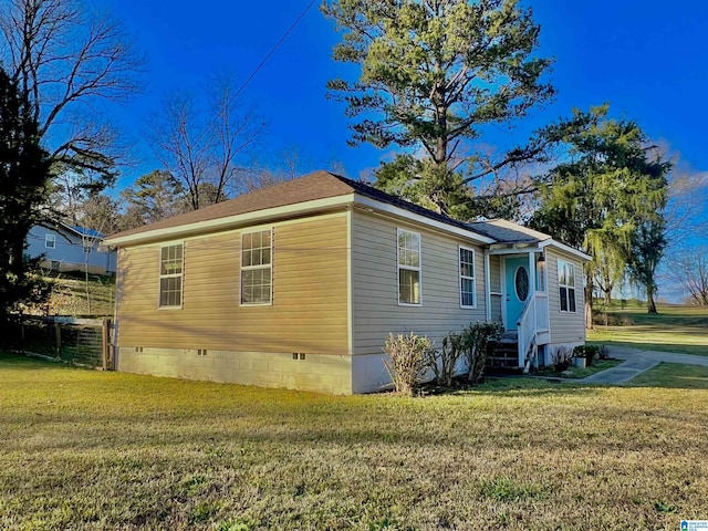 view of property exterior with a lawn