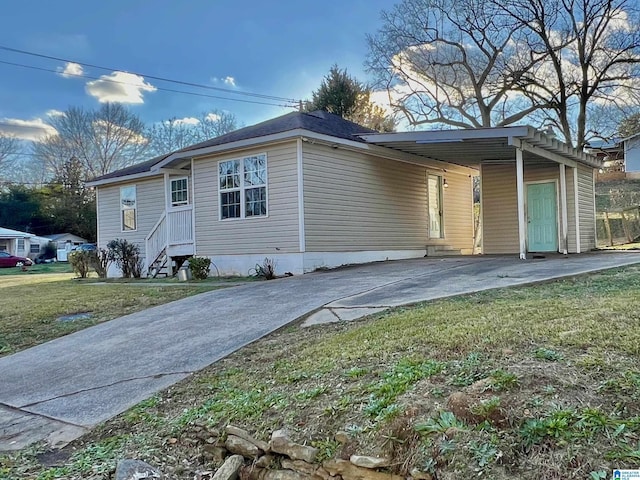 view of front of property with a front yard and a carport