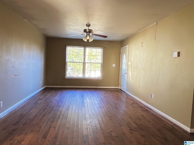 spare room with ceiling fan and dark wood-type flooring