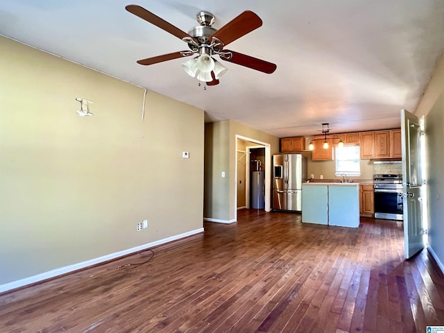 kitchen with ceiling fan, sink, dark hardwood / wood-style flooring, decorative light fixtures, and appliances with stainless steel finishes