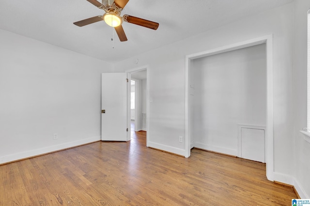 unfurnished bedroom with ceiling fan and light wood-type flooring