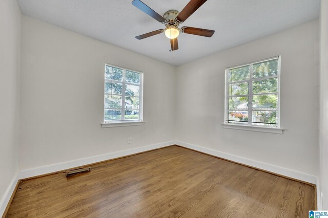 empty room featuring hardwood / wood-style flooring and ceiling fan