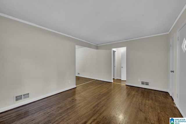 empty room with crown molding and dark wood-type flooring