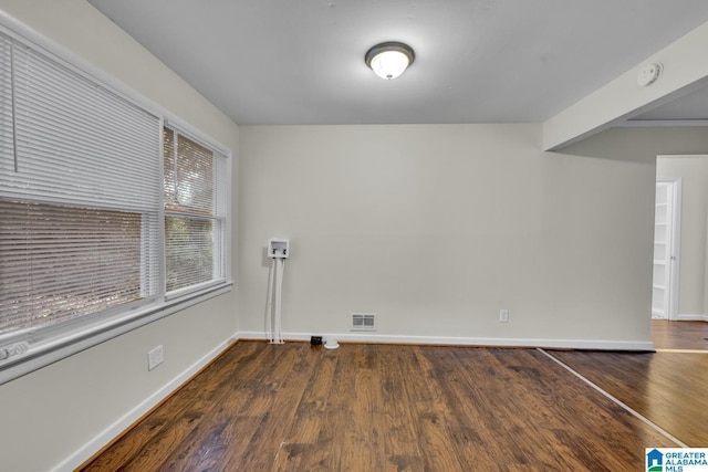 empty room featuring dark hardwood / wood-style flooring