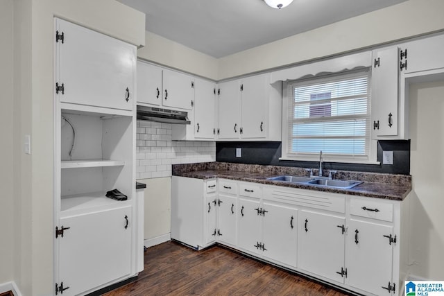 kitchen featuring backsplash, dark hardwood / wood-style floors, white cabinetry, and sink