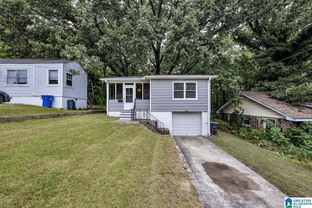 view of front of home with a front yard and a garage