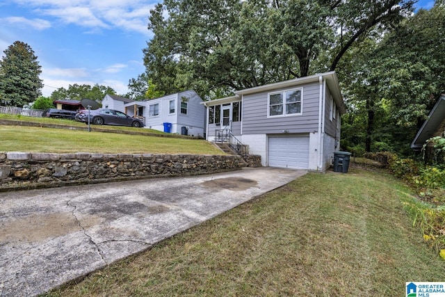 raised ranch with a garage and a front lawn