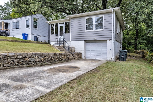 view of front of property with a sunroom, a front lawn, and a garage