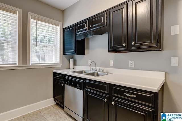 kitchen with dishwasher, light tile patterned floors, and sink