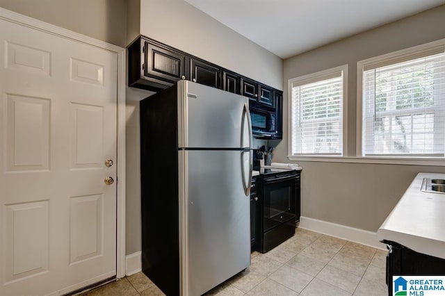 kitchen with sink, light tile patterned floors, and black appliances