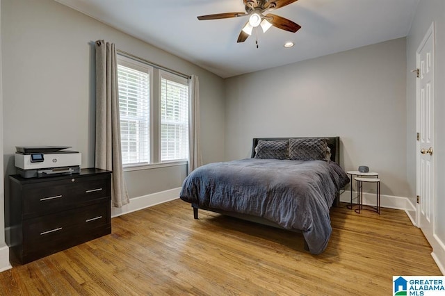 bedroom with light hardwood / wood-style flooring and ceiling fan