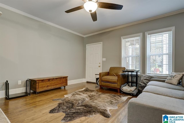 living room featuring ceiling fan, wood-type flooring, and ornamental molding