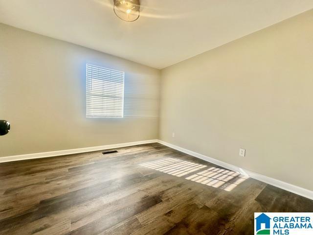 unfurnished room featuring dark hardwood / wood-style floors