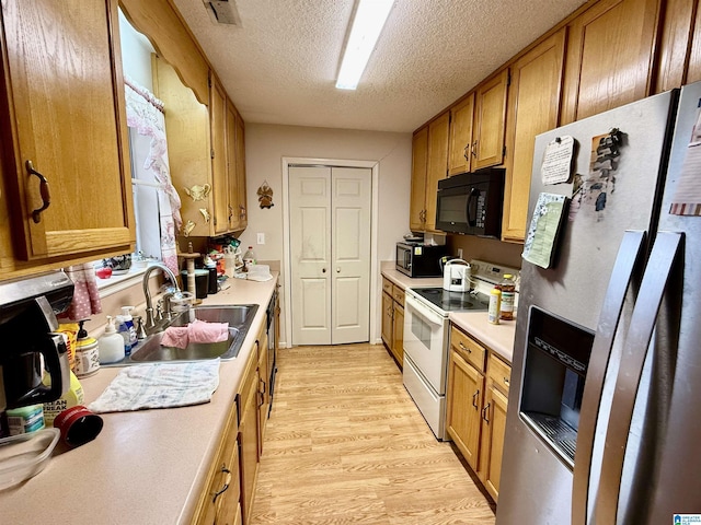 kitchen with sink, light hardwood / wood-style flooring, stainless steel refrigerator with ice dispenser, white electric stove, and a textured ceiling