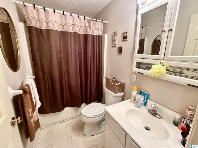 bathroom featuring vanity, toilet, and a textured ceiling