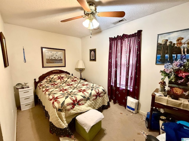 bedroom with a textured ceiling and ceiling fan