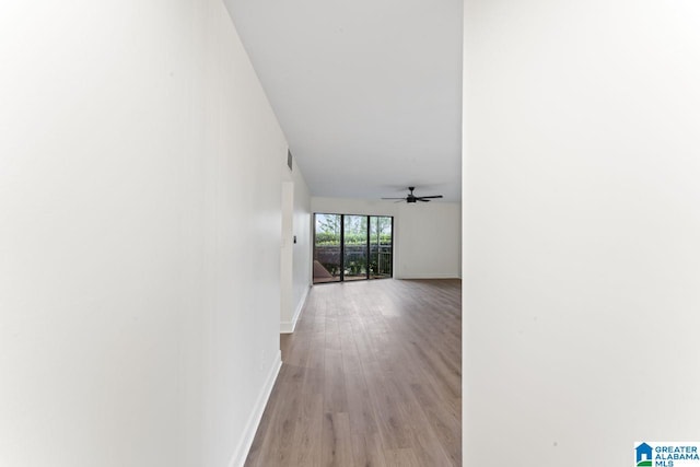 hallway with light hardwood / wood-style floors