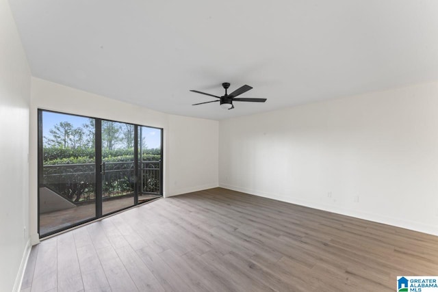 spare room with light hardwood / wood-style floors and ceiling fan