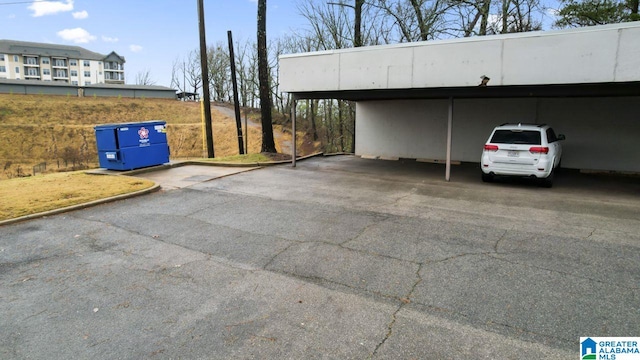 view of parking / parking lot featuring a carport