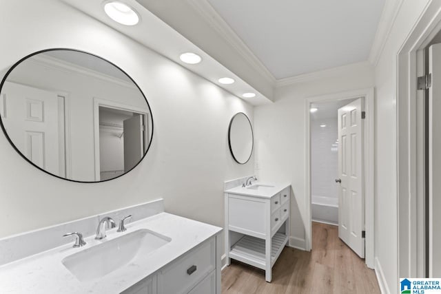 bathroom with shower / tub combination, vanity, hardwood / wood-style flooring, and ornamental molding