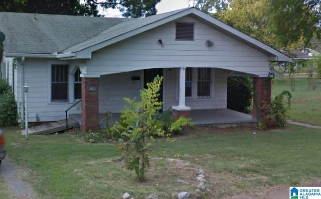 view of front of home with a front yard and a porch