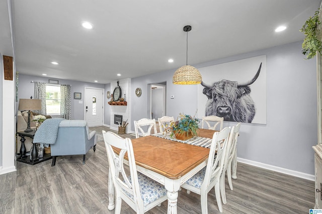 dining space featuring dark hardwood / wood-style floors and a fireplace