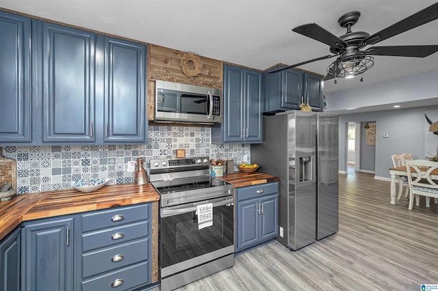 kitchen featuring wooden counters, appliances with stainless steel finishes, blue cabinetry, and ceiling fan