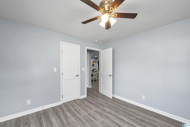 spare room with hardwood / wood-style flooring and ceiling fan