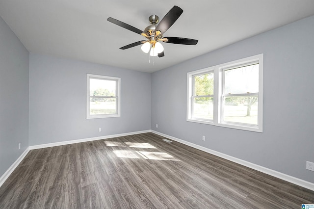 empty room featuring ceiling fan and dark wood-type flooring