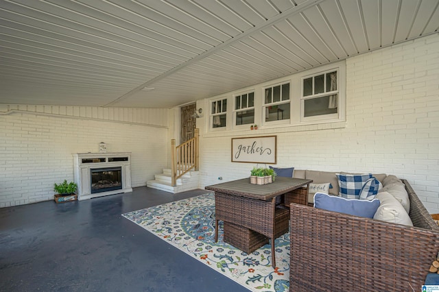 exterior space featuring a fireplace and brick wall