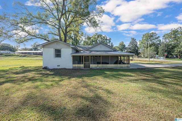 view of front of house featuring a sunroom and a front lawn