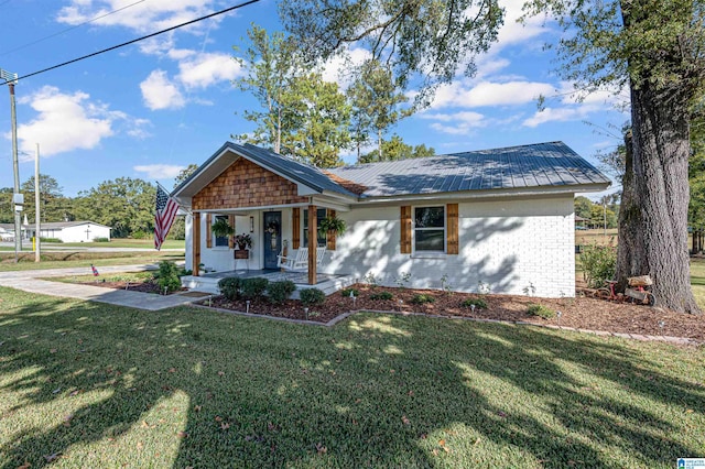 view of front of house with a front yard and a porch