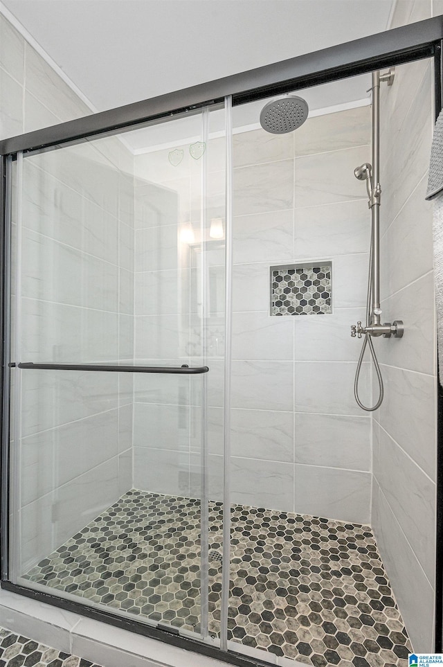 bathroom with a shower with shower door