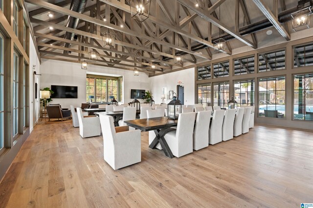 1616 Skye Pass, Hoover, AL 35244 - dining area with beam ceiling, a towering ceiling, and light hardwood / wood-style flooring