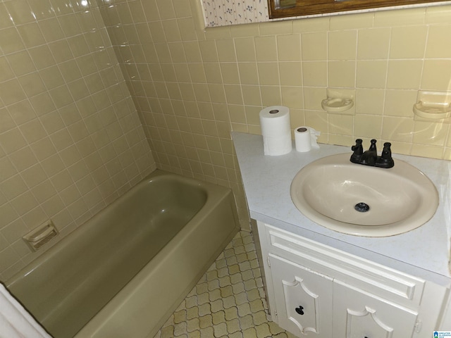 bathroom featuring tile patterned flooring, vanity, and tile walls